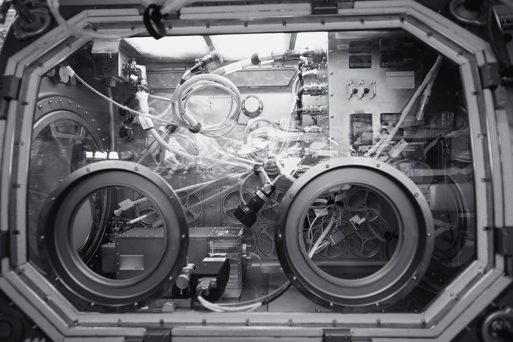 Sealed laboratory glovebox with two round glove ports aboard a space station